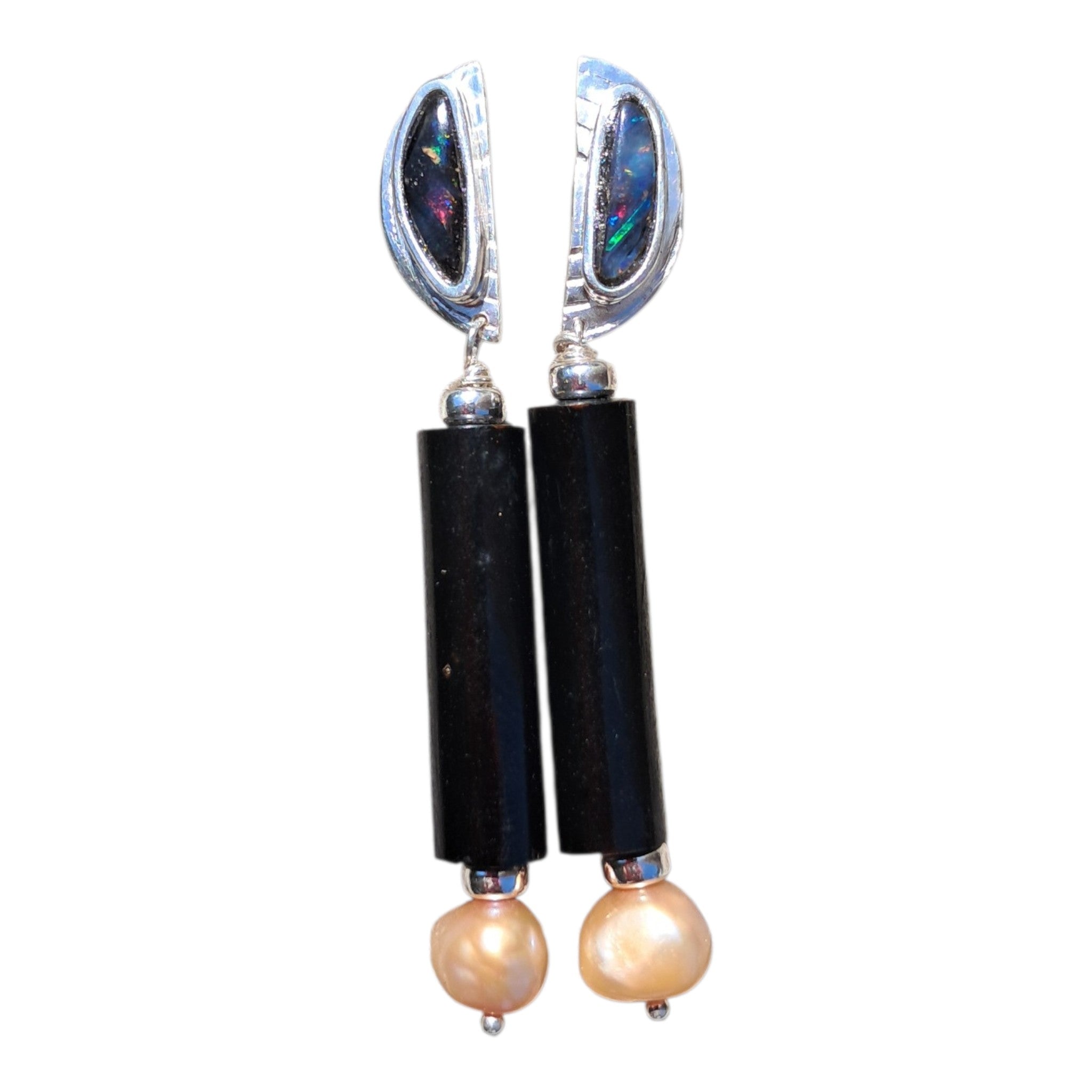 Pair of earrings with black cylindrical beads and pearl-like stones on a white background