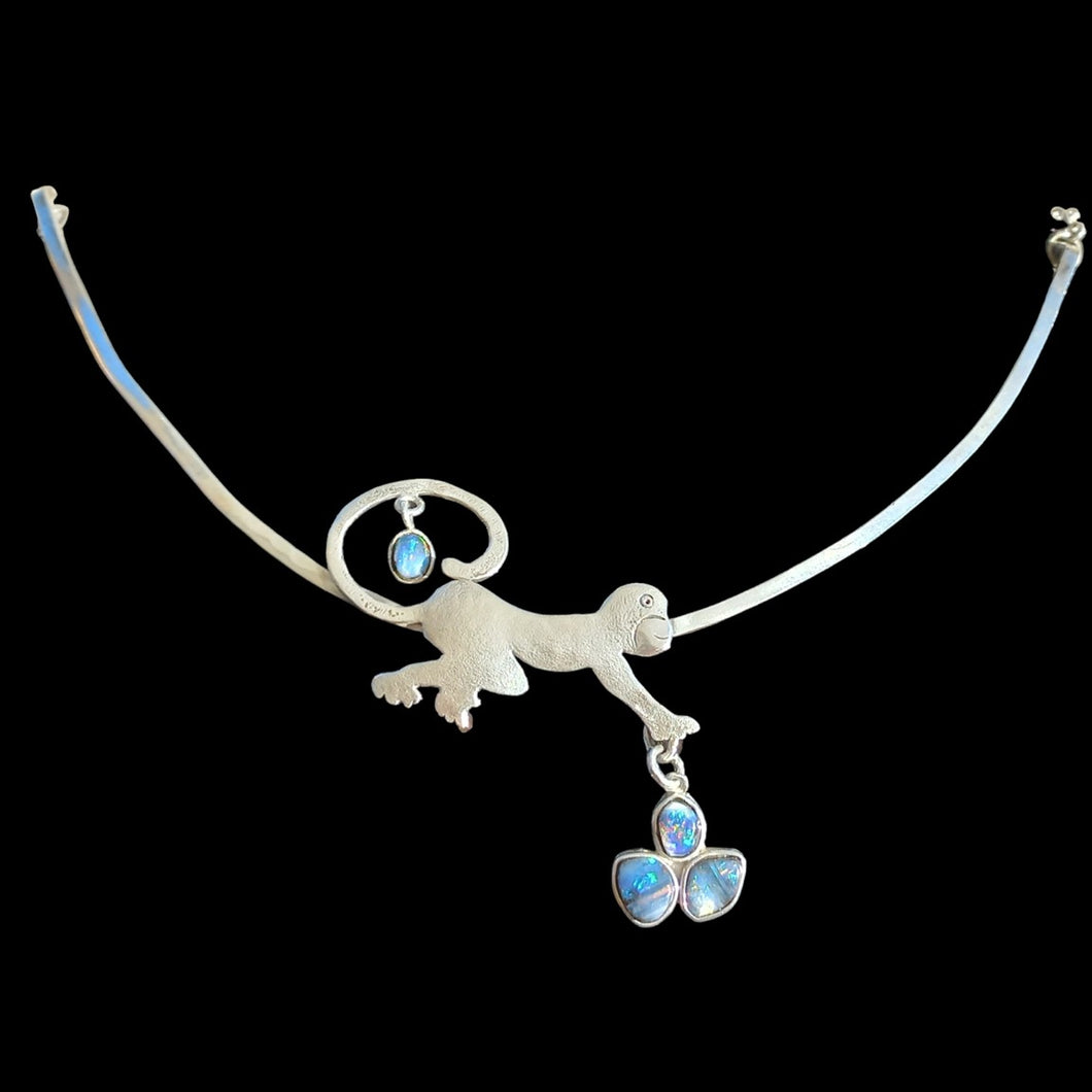 Playful monkey pendant with genuine black opals